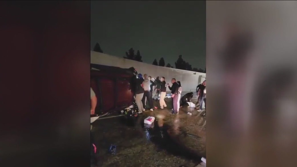Video shows group of people helping driver in overturned vehicle